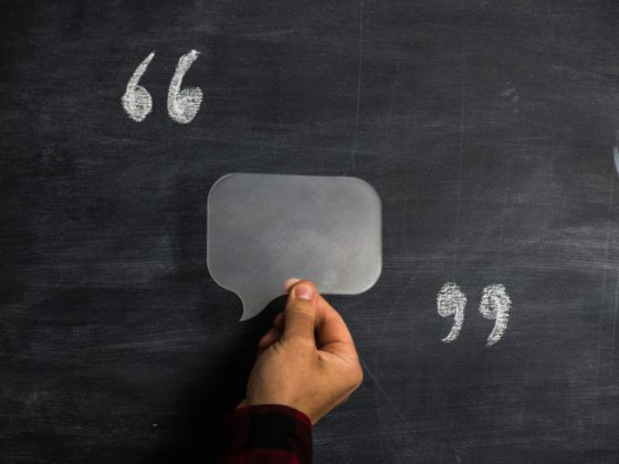 A person holding a transparent speech balloon